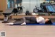 A woman laying on a yoga mat in a gym.