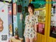 A woman standing in front of a store with a pineapple.