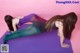 A couple of women laying on top of a purple mat.