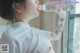 A woman drinking water from a plastic bottle.