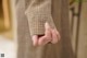 A close up of a person's hand holding a piece of clothing.